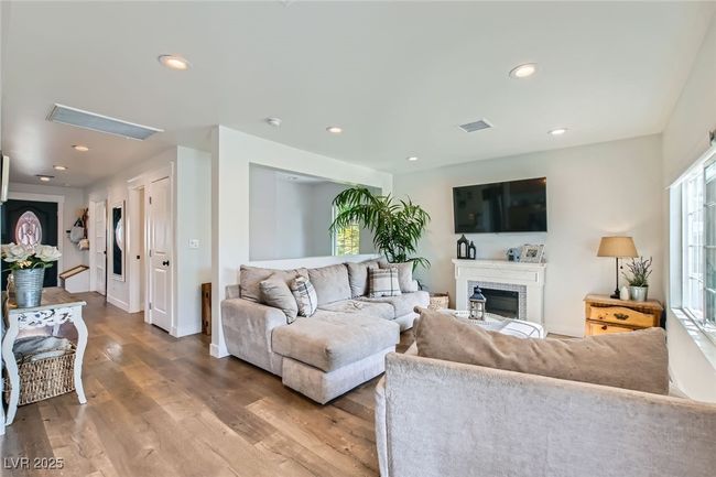Living area featuring wood finished floors, recessed lighting, and baseboards | Image 7