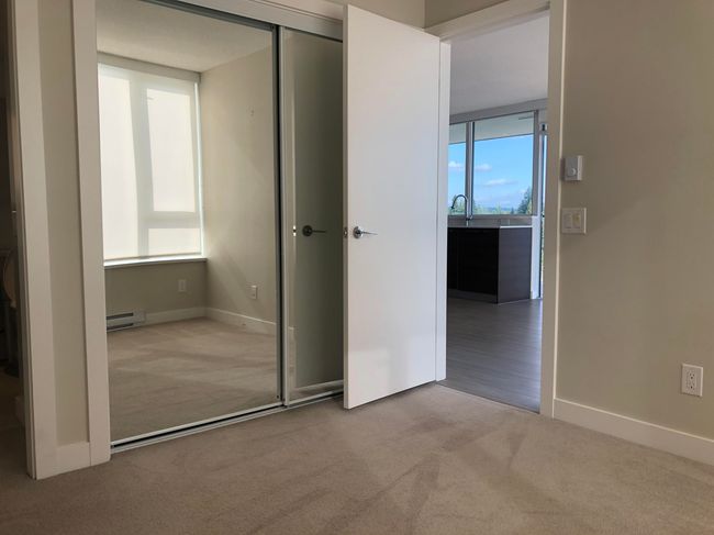 Unfurnished bedroom with carpet, a closet, baseboards, and a baseboard radiator | Image 8