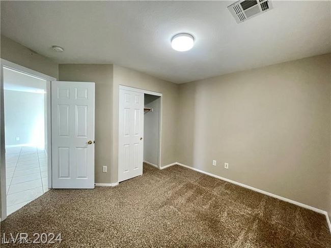 Unfurnished bedroom with baseboards, visible vents, a closet, and carpet flooring | Image 18