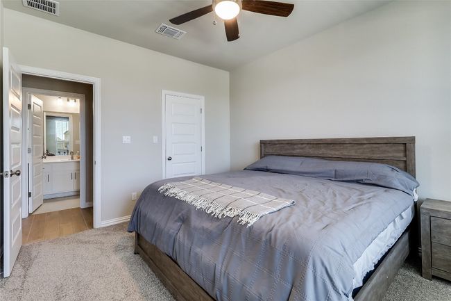 Bedroom featuring carpet floors, ceiling fan, and baseboards | Image 27