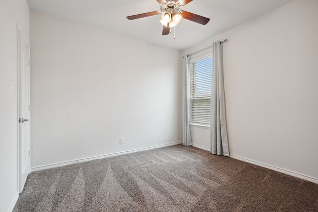 Carpeted spare room with a ceiling fan and baseboards | Image 21