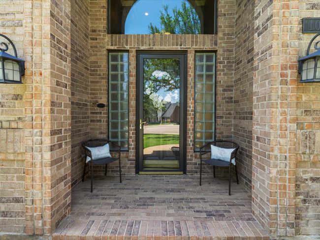 Doorway to property featuring brick siding | Image 5