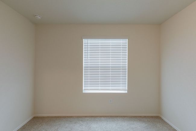 Spare room featuring carpet floors, baseboards, and a smoke detector | Image 12