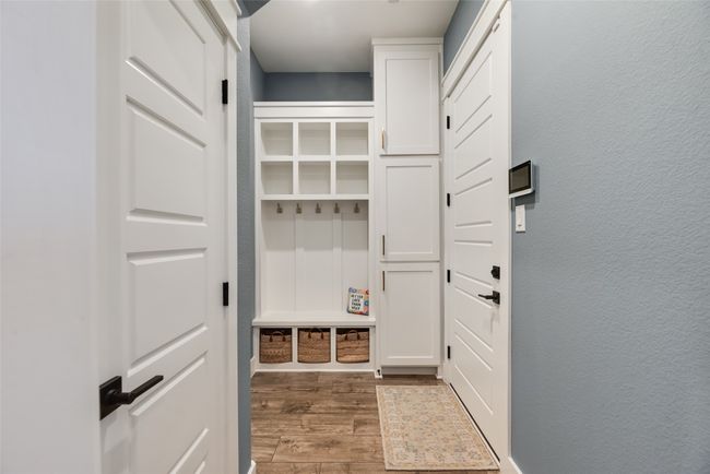 Mudroom featuring wood finished floors and a textured wall | Image 17