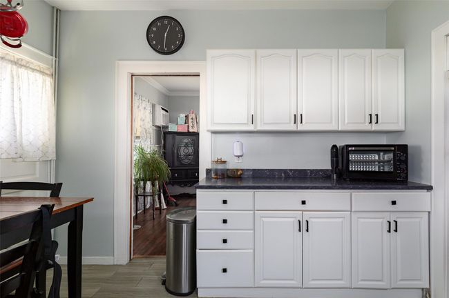 Kitchen with white cabinetry and ornamental molding | Image 4