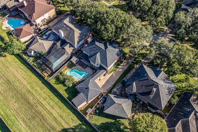 Ariel view of the home shows the green space located behind the row of homes on Pecan Crossing. No back neighbors!! | Image 43