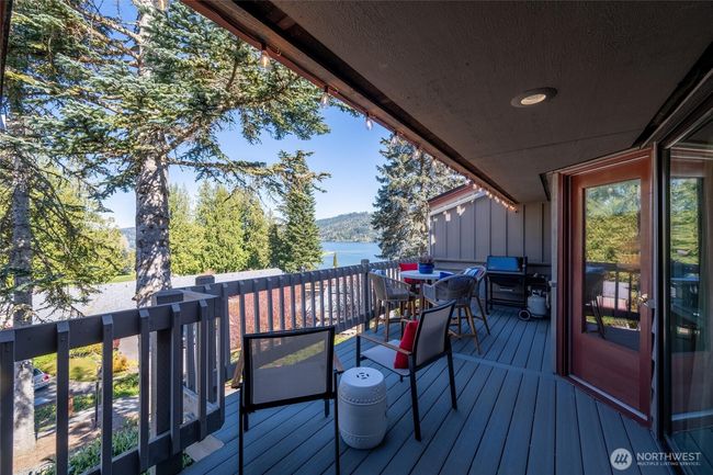 Expansive, afternoon-side deck with living room, primary bedroom, and 2nd bedroom access. | Image 16