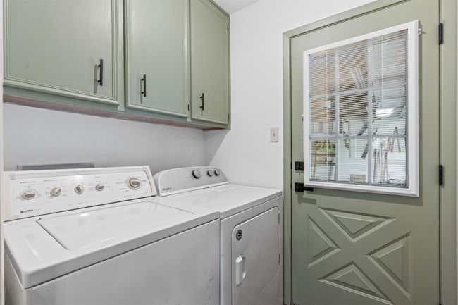 Laundry room with cabinet space and washer and clothes dryer | Image 24