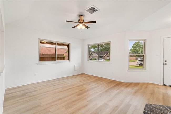 Front living space blends traditional and modern touches, with layered ceiling height and good natural light. | Image 5