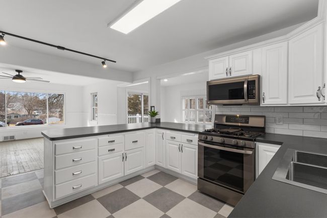 Enameled cabinetry and generous counterspace including a oversized breakfast bar | Image 9