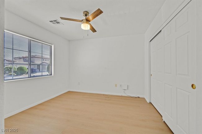 Unfurnished bedroom with light wood-style floors, a closet, and ceiling fan | Image 12
