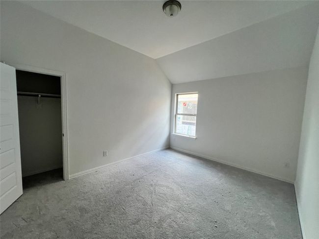 Unfurnished bedroom featuring carpet floors and lofted ceiling | Image 7