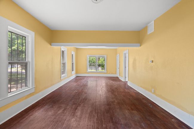 Unfurnished room with wood finished floors and baseboards | Image 7