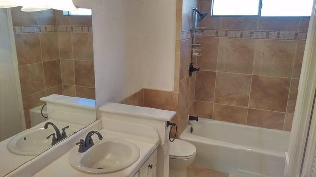 Full bath featuring toilet, vanity, and shower / washtub combination | Image 6