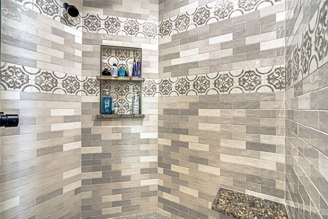 Bathroom featuring a custom tile shower | Image 26