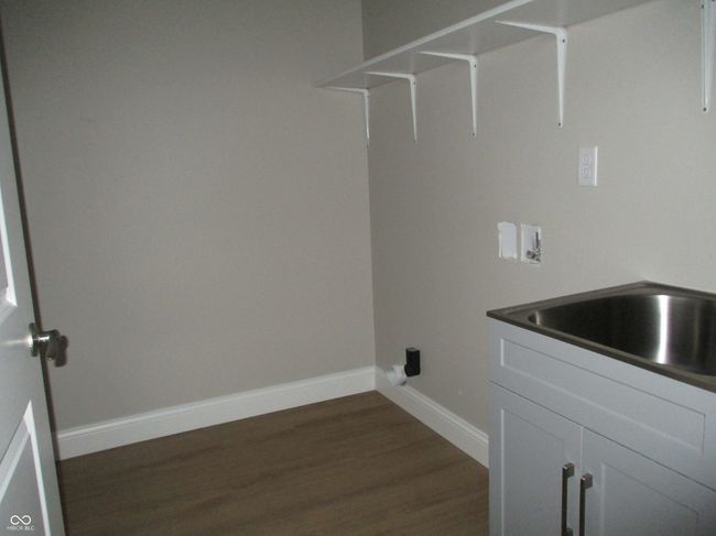 laundry room with washer hookup, baseboards, and dark wood-style flooring | Image 17