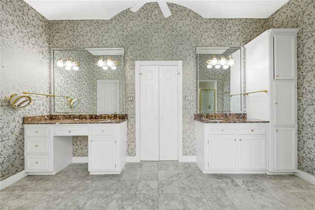 Elegant dual sinks with dedicated vanity seating area. | Image 32