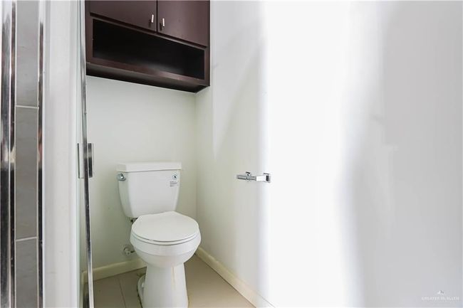 Bathroom with tile patterned flooring, toilet, and baseboards | Image 20