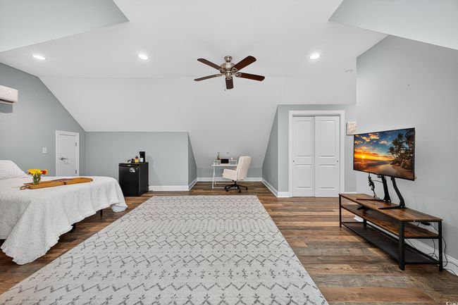 Bedroom with vaulted ceiling, dark wood-type flooring, recessed lighting, a ceiling fan, and a closet | Image 35
