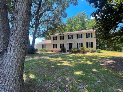 Colonial inspired home featuring a front yard | Image 2