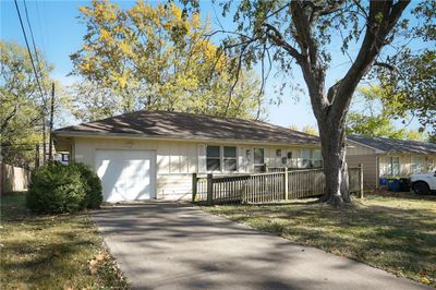 Ranch-style house featuring a front yard and a garage | Image 3