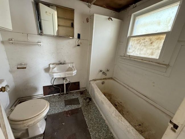Full bathroom featuring toilet, a sink, and bathing tub / shower combination | Image 15