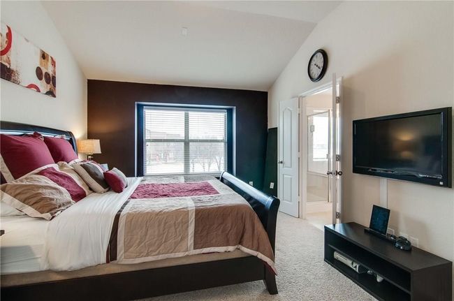 Bedroom featuring multiple windows, lofted ceiling, and carpet floors | Image 21