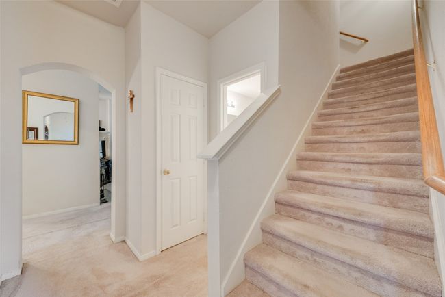 Dining space with light carpet, arched walkways, a chandelier, baseboards, and ornamental molding | Image 30
