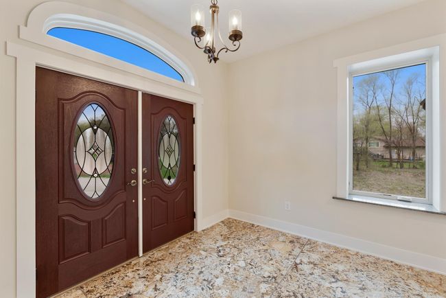 French doors open to the sprawling granite entry way | Image 5