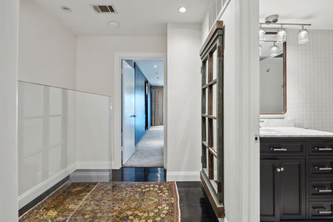 Landing area upstairs where entry for each primary bath is. | Image 19
