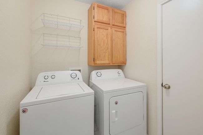 Laundry room with cabinet space and washing machine and clothes dryer | Image 22