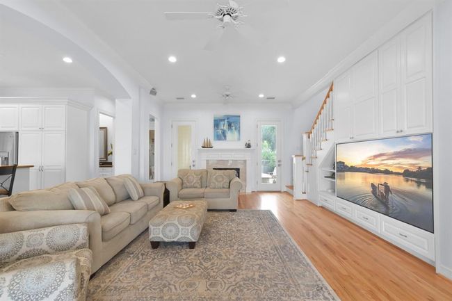 Cozy den featuring a gas fireplace and a built-in large screen TV. | Image 11