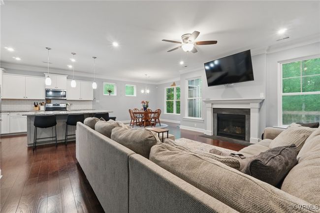 Open-concept great room with fireplace and seamless flow to the kitchen. | Image 11