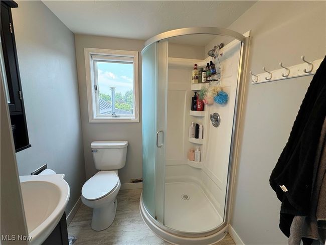 Second floor bathroom featuring a shower stall and a sink | Image 23