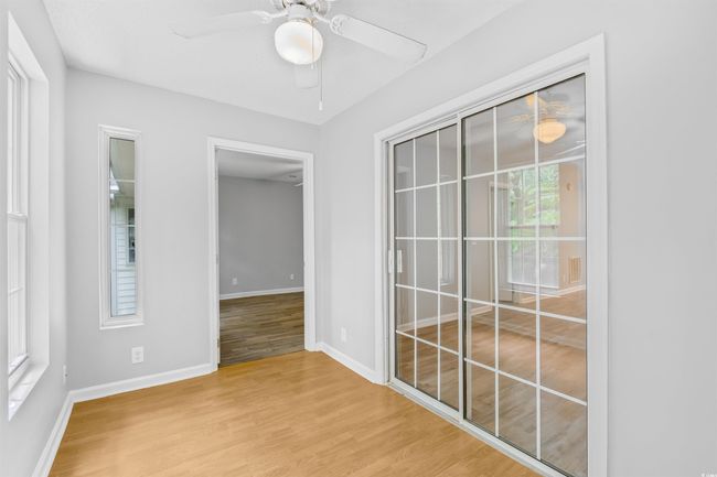 Empty room featuring wood finished floors and a ceiling fan | Image 27