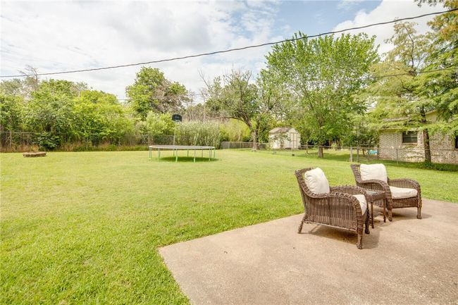 View of yard with a trampoline and a patio area | Image 20
