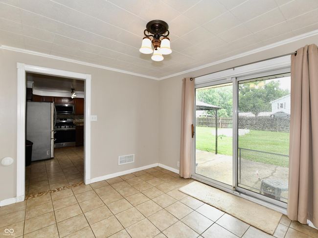 Dining room wiith sliding glass door leading out to the backyard. | Image 17
