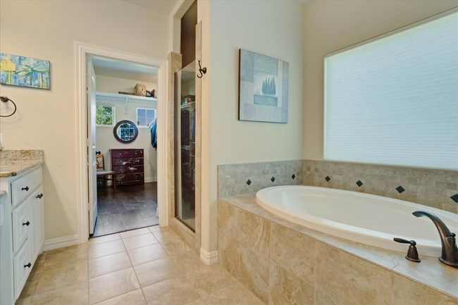 Full bathroom with a bath, vanity, tile patterned flooring, a shower stall, and baseboards | Image 14