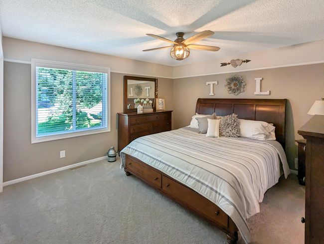 Generous primary bedroom has loads of closed space and overlooks natural views. | Image 15
