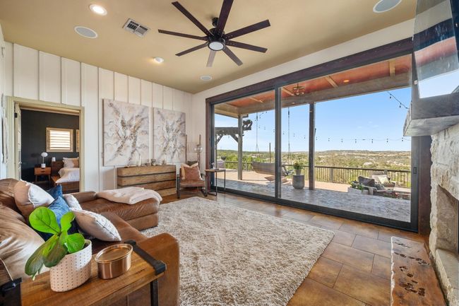 Living room with visible vents, a healthy amount of sunlight, tile patterned flooring, and a ceiling fan | Image 4