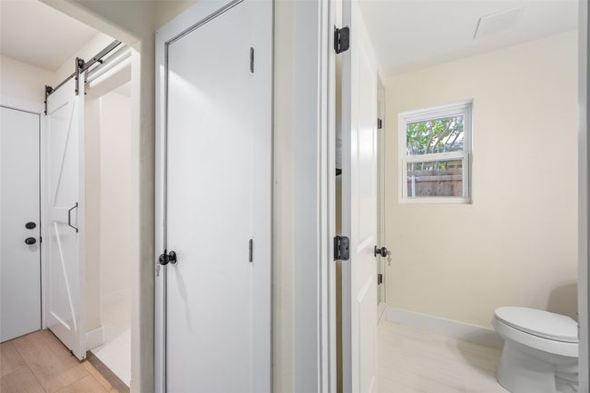 Corridor with a barn door and baseboards | Image 25