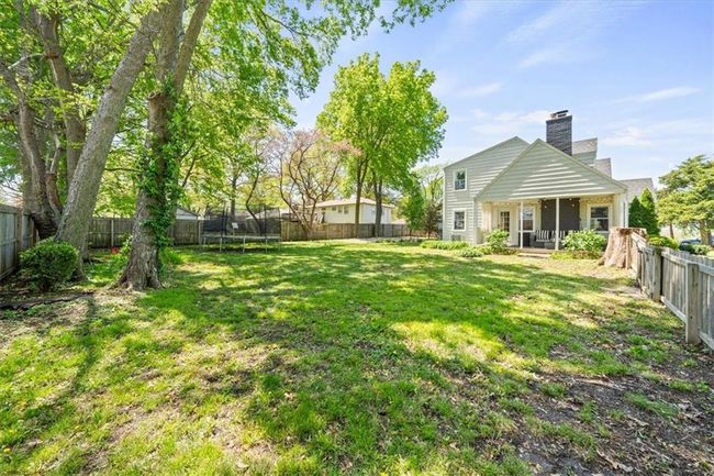 View of yard with a trampoline and a fenced backyard | Image 27
