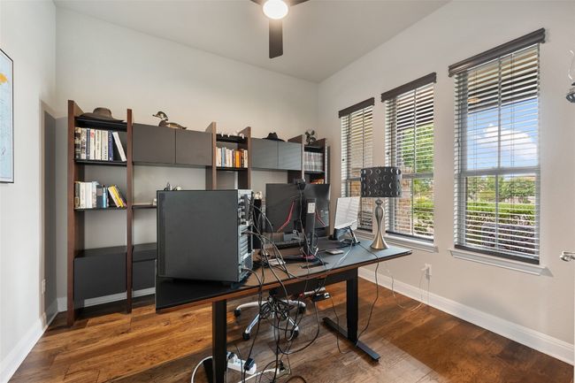 Office space with a ceiling fan and wood finished floors | Image 7