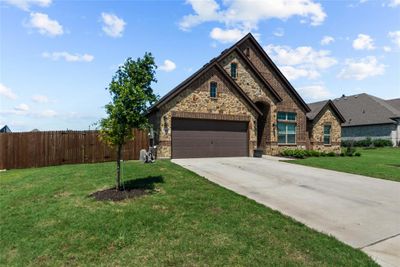 View of front facade with a front yard and a garage | Image 3