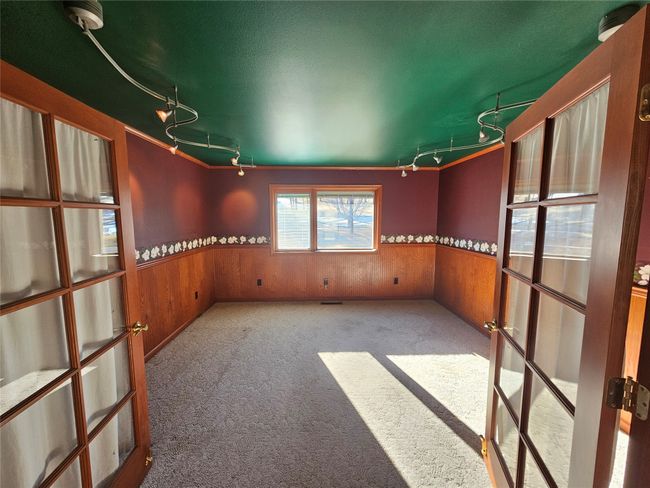 This room is perfect for hanging your pictures or paintings as has overhead lights highlighting them. | Image 15