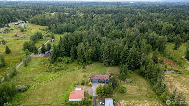 Spanning over 4, 000 sq ft, the residence sits on a captivating 8+ acre parcel—half lush woods with meandering trails, half sun-drenched open space, all infused with privacy and natural beauty. | Image 30