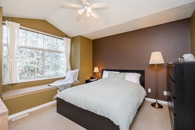 Bedroom featuring light carpet, visible vents, baseboards, and lofted ceiling | Image 13