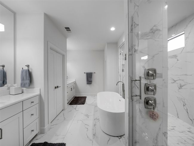 Full bath featuring vanity, a marble finish shower, a freestanding tub, marble finish floors, and recessed lighting | Image 24