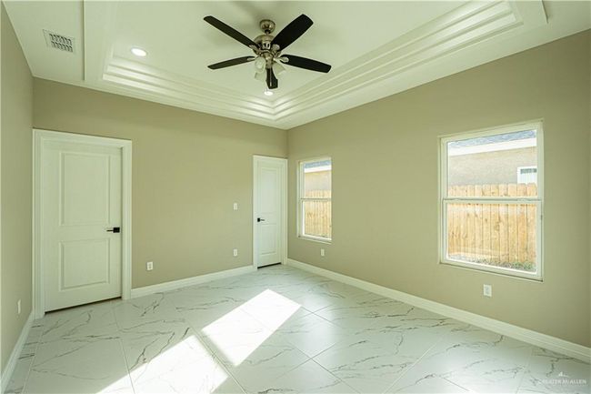 Spare room with marble finish floor, a raised ceiling, and baseboards | Image 9