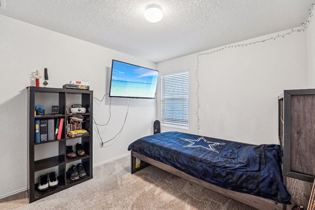 Carpeted bedroom with baseboards and a textured ceiling | Image 15